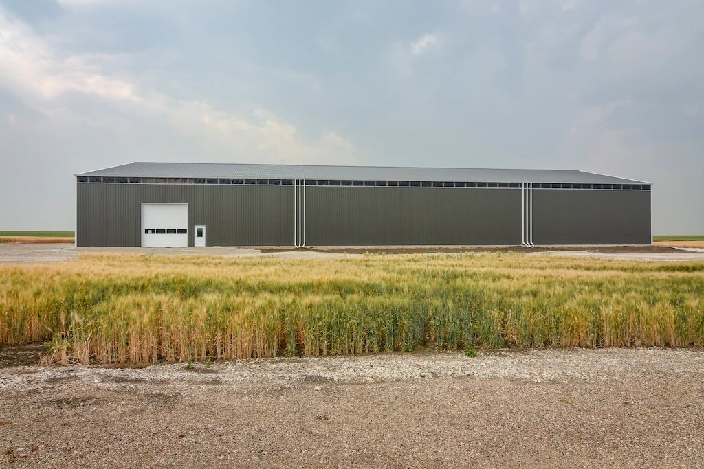 200' long pole barn machine shed with wall light panels