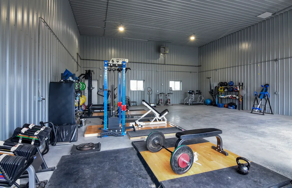 The interior of a multi-use post frame facility used for training elite athletes. The 40' x 60' building has a full range of gym equipment.