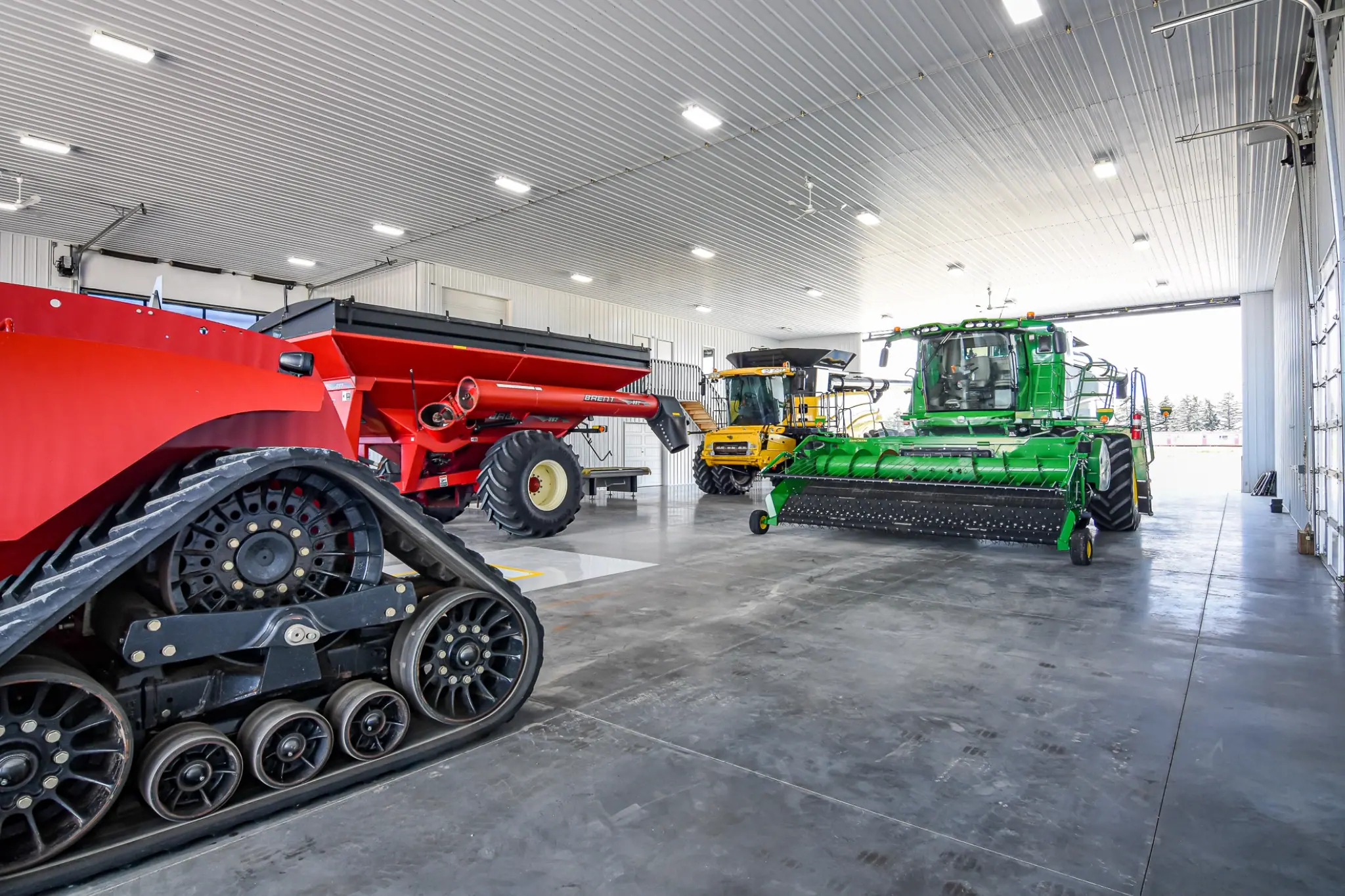 Interior of a clean, durable, productive farm building used for equipment storage and maintenance for tractors, combines, trucks, and other agricultural machines.