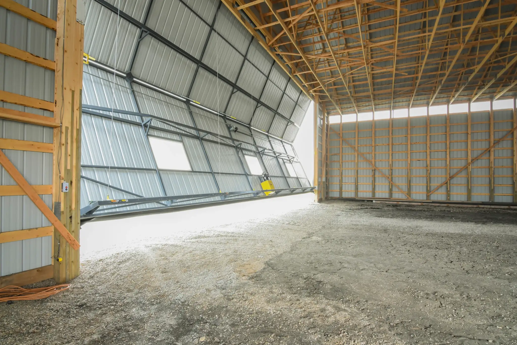 Windows and wall lights installed throughout this cold storage for farm equipment create a brightly lit interior during the day.