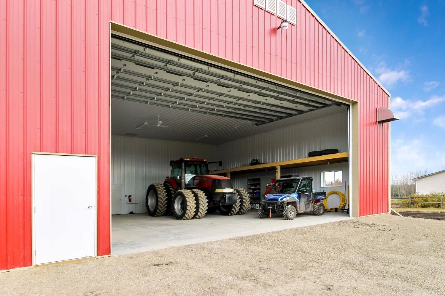 A heated shop building interior shows a complete finish inside for a productive interior, including wall metal, concrete flooring, and a mezzanine.