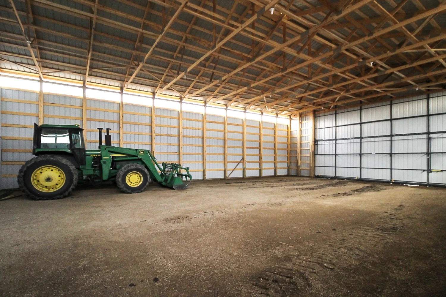 Unfinished machine storage inside a larger shop building provides shelter for valuable equipment.
