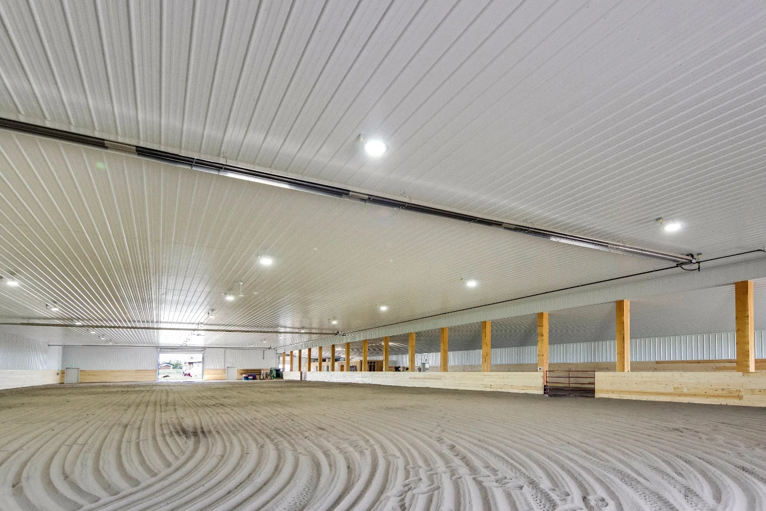 A fully finished custom indoor riding arena with perfectly groomed footing, protective kick wall provides a safe, fun space for year-round riding.