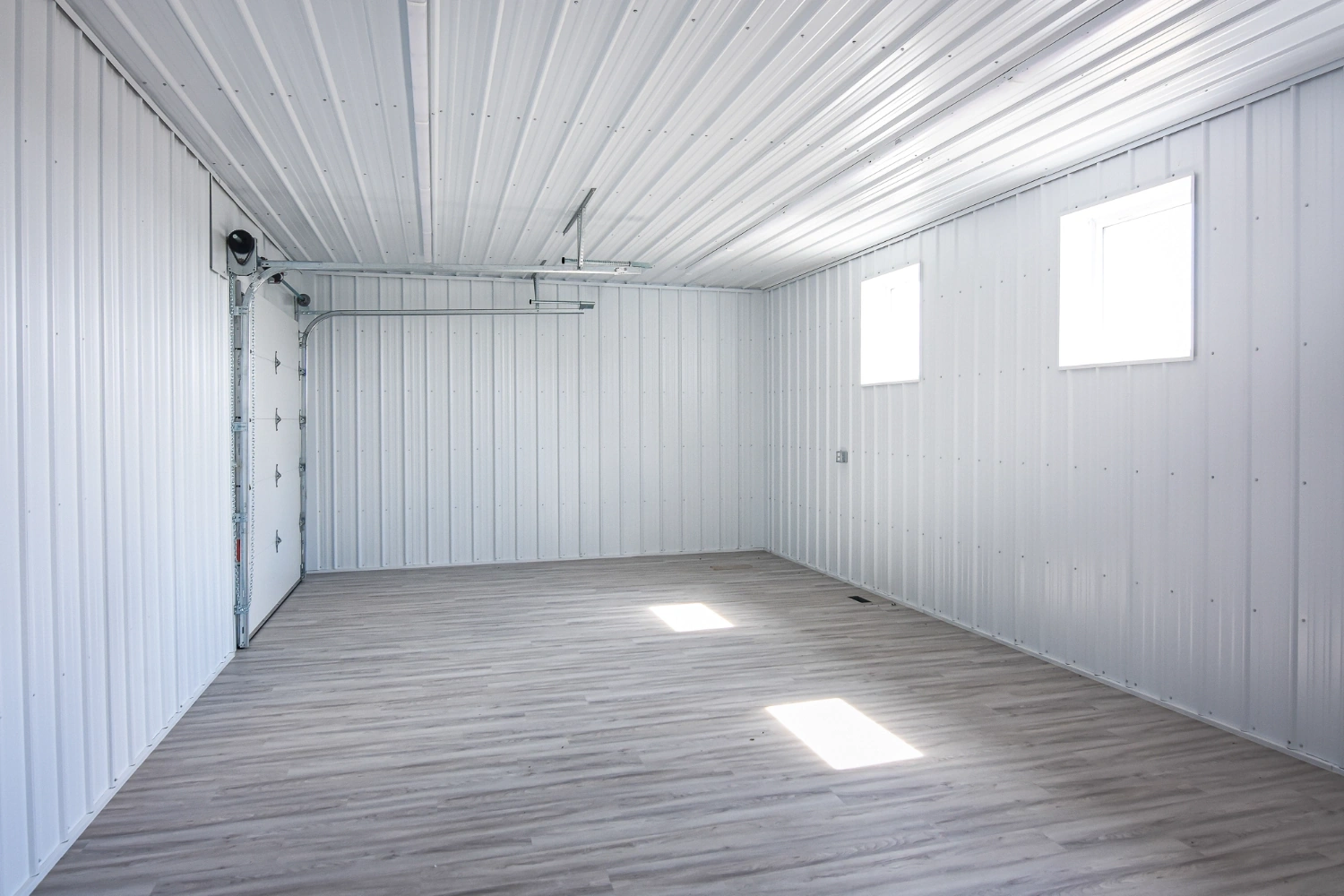 A mezzanine in an agricultural building provides second floor function in the form of a storage room.