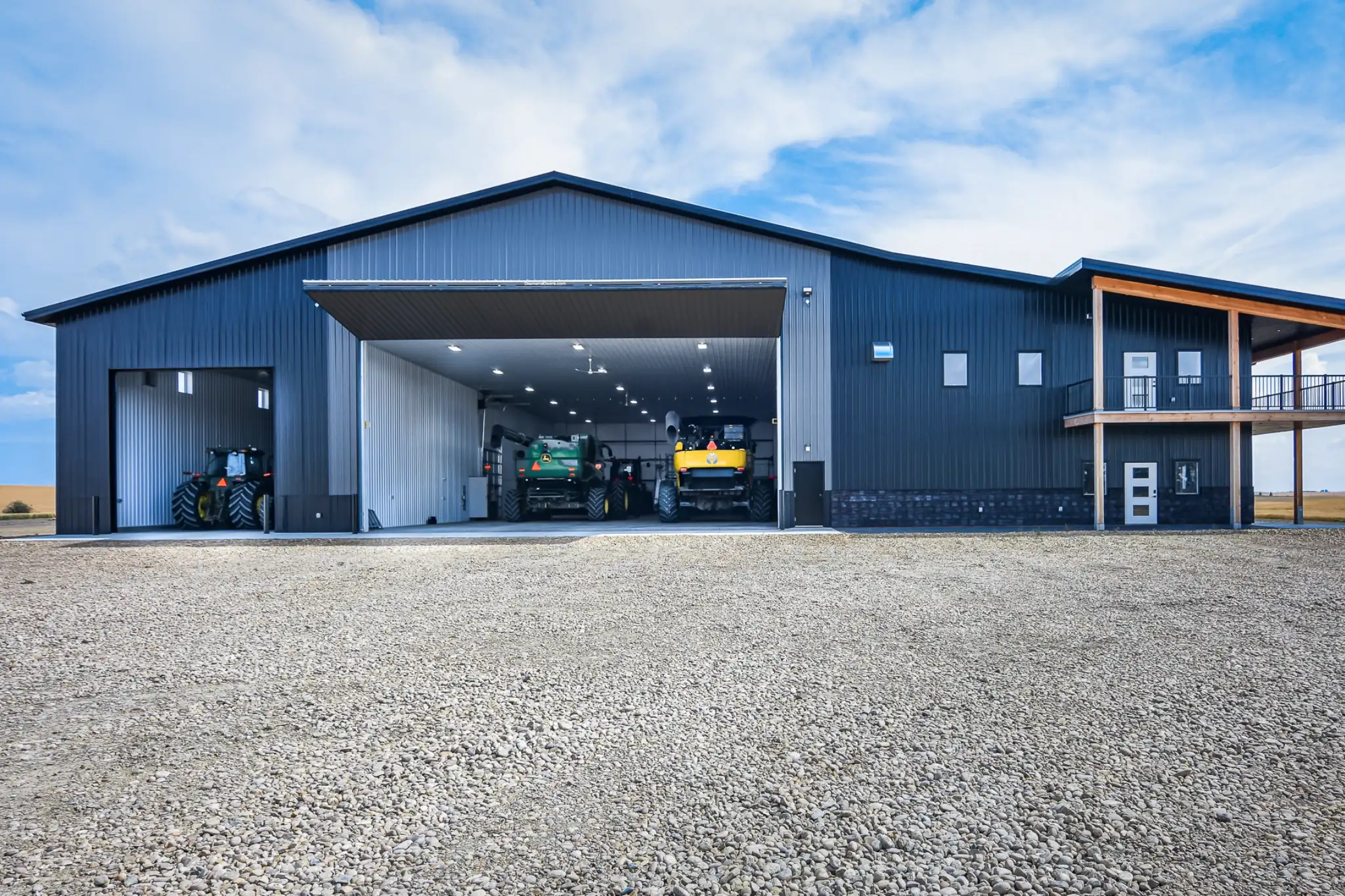 All doors are open on this agricultural building, displaying the many uses. From storage to equipment maintenance, it helps the farm operate smoothly.