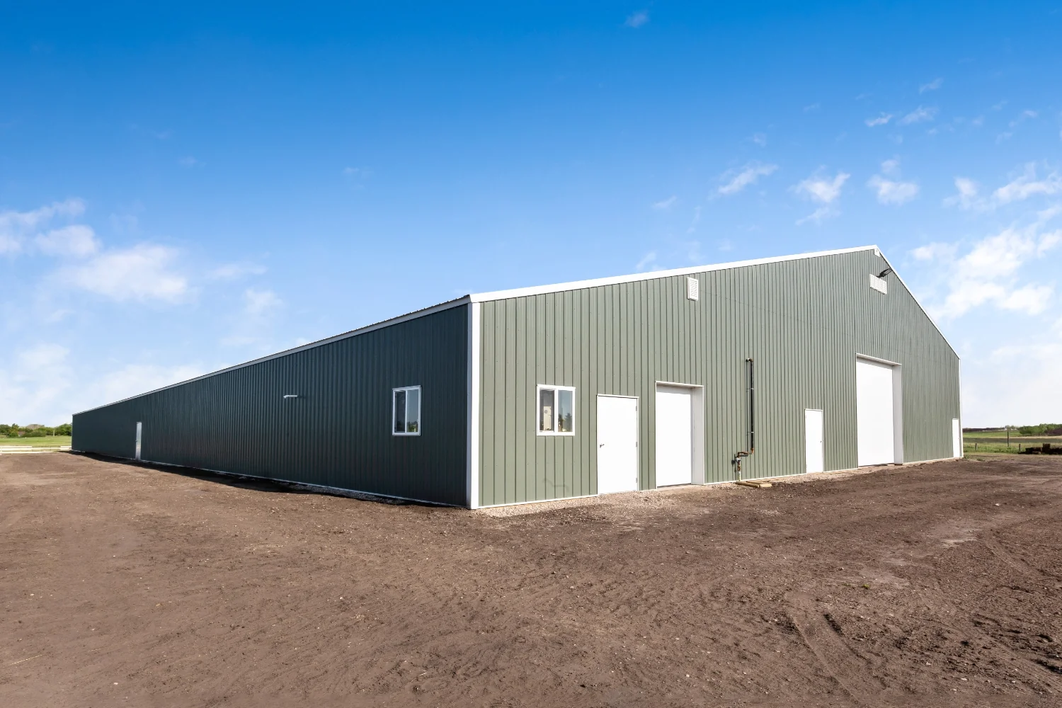 S side angle of an indoor riding arena shows the vast length.