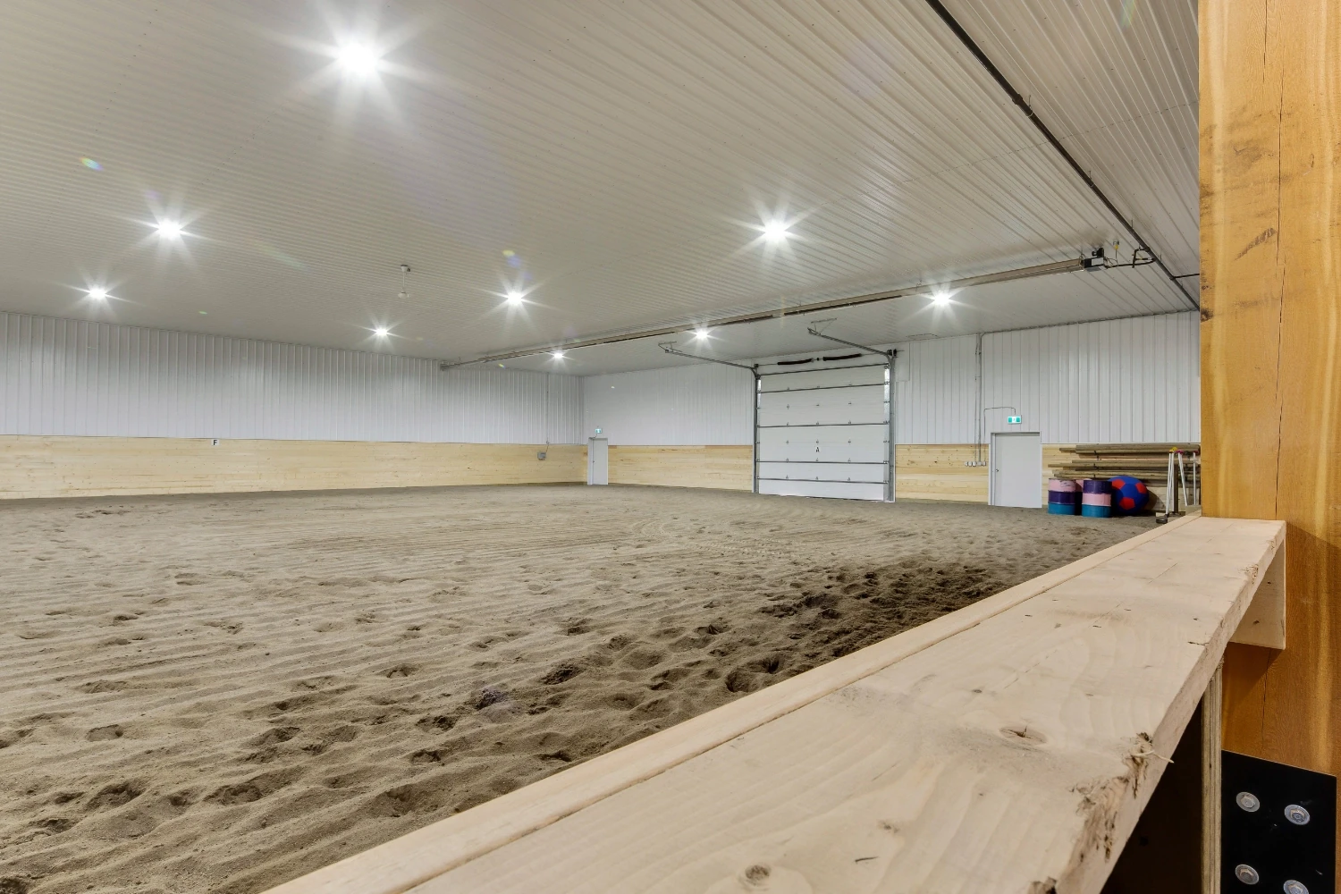 Fully finished indoor riding arena with safe footing for horses and enjoyable environment for riders.