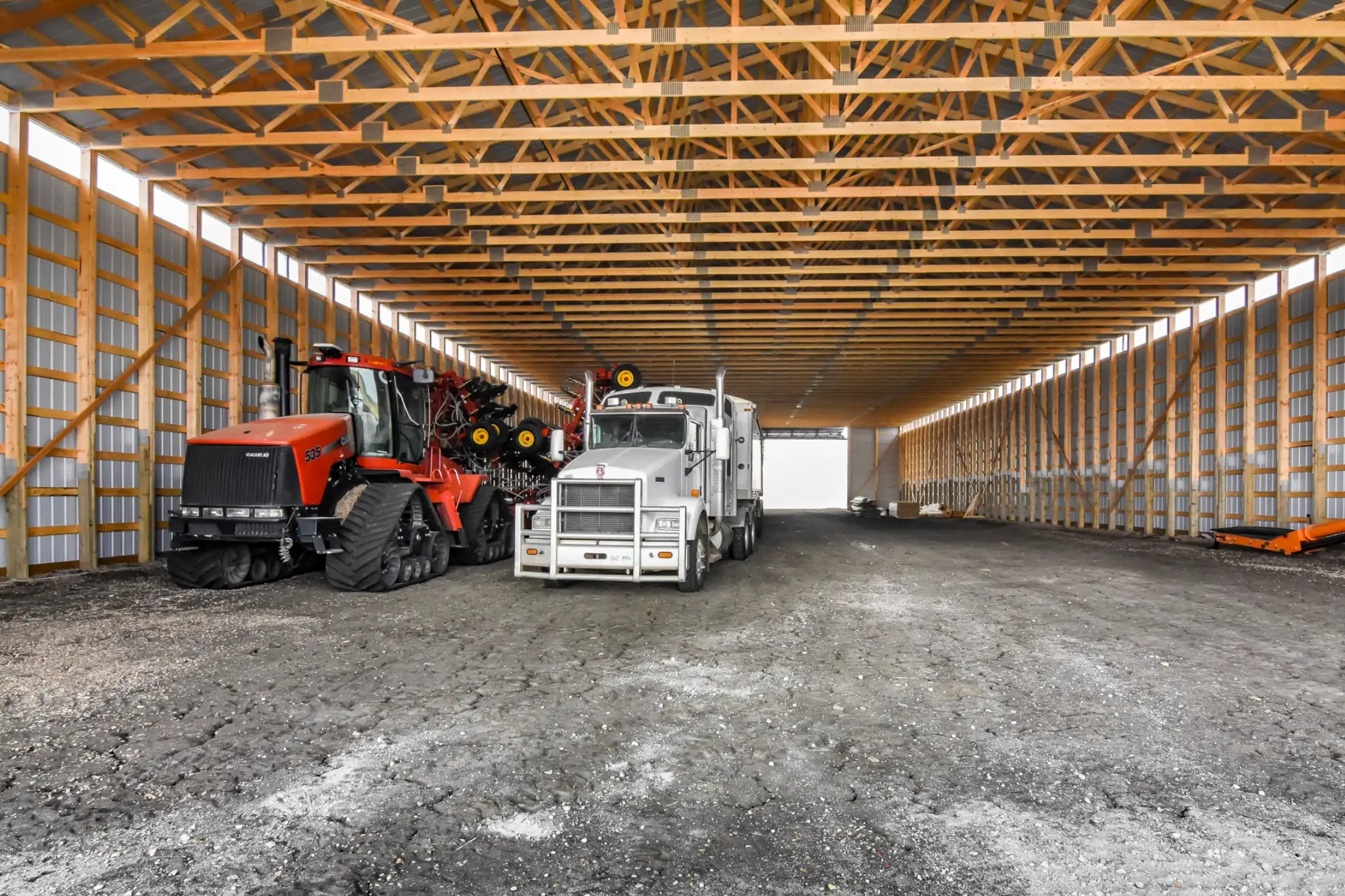 Interior of a post frame building for cold storage of farm equipment.