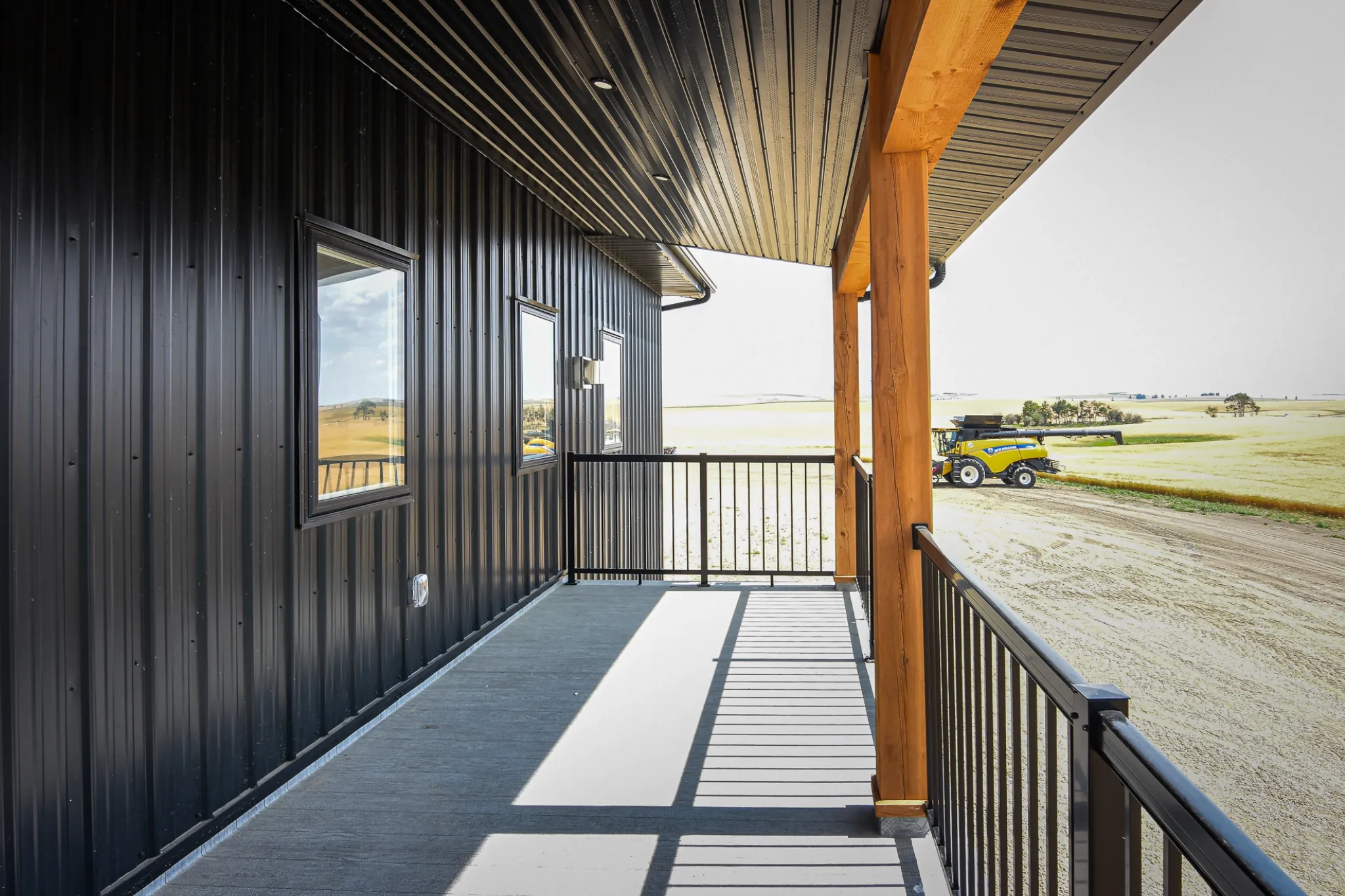 The view from a second story balcony of a fancy agricultural building.