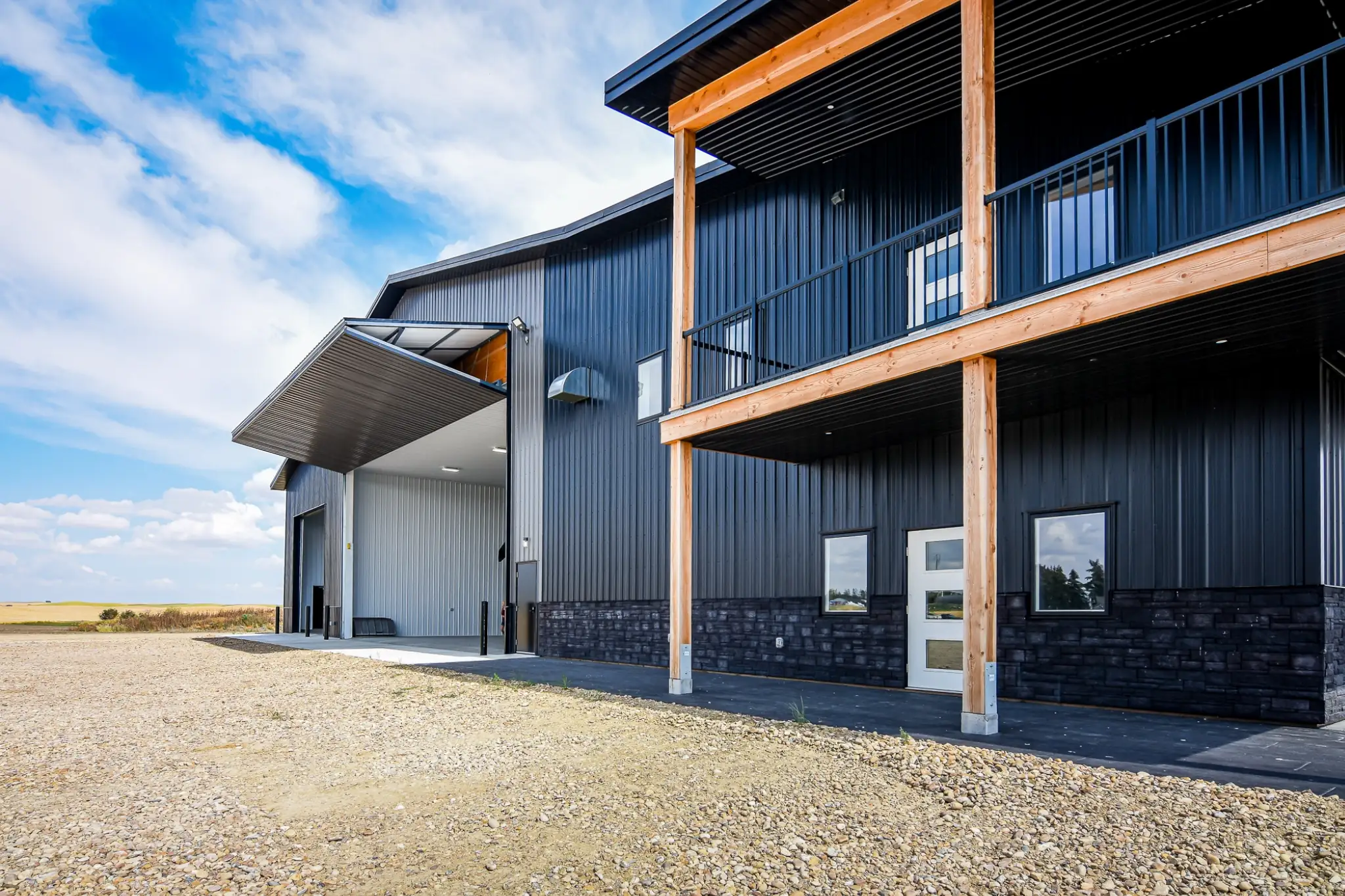 Striking details on a fancy agricultural building, including a porch and stone accents for an elevated look.