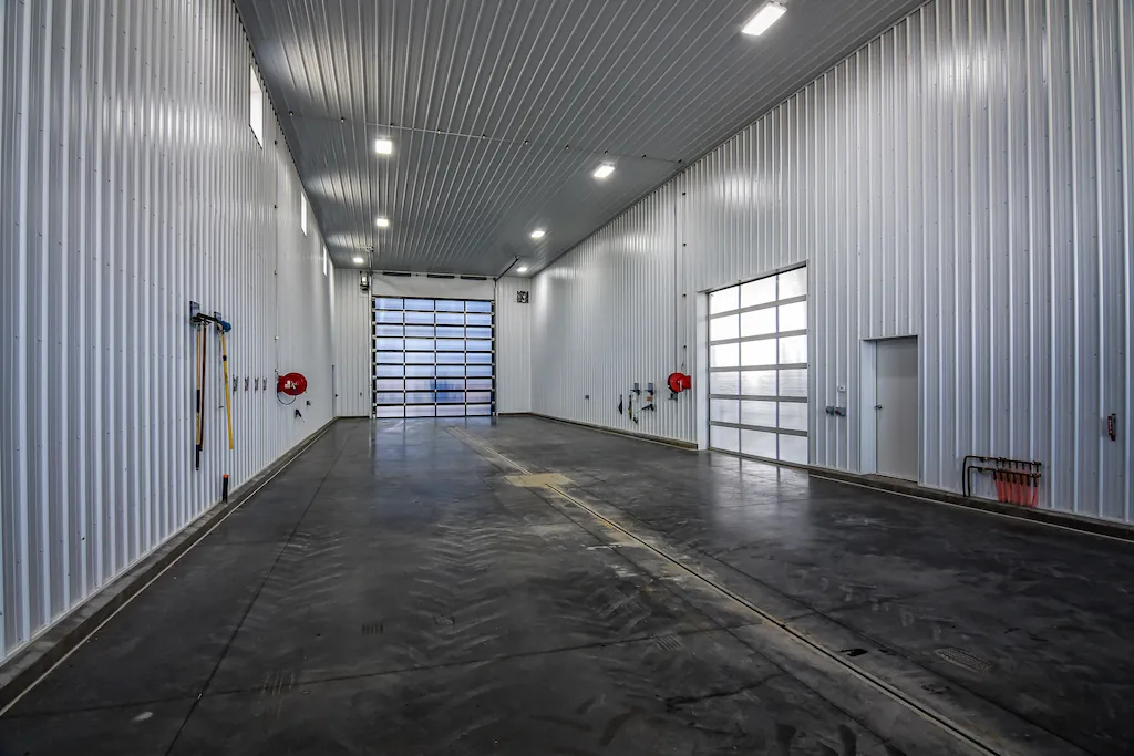 Farm equipment wash bay section of a pole barn workshop