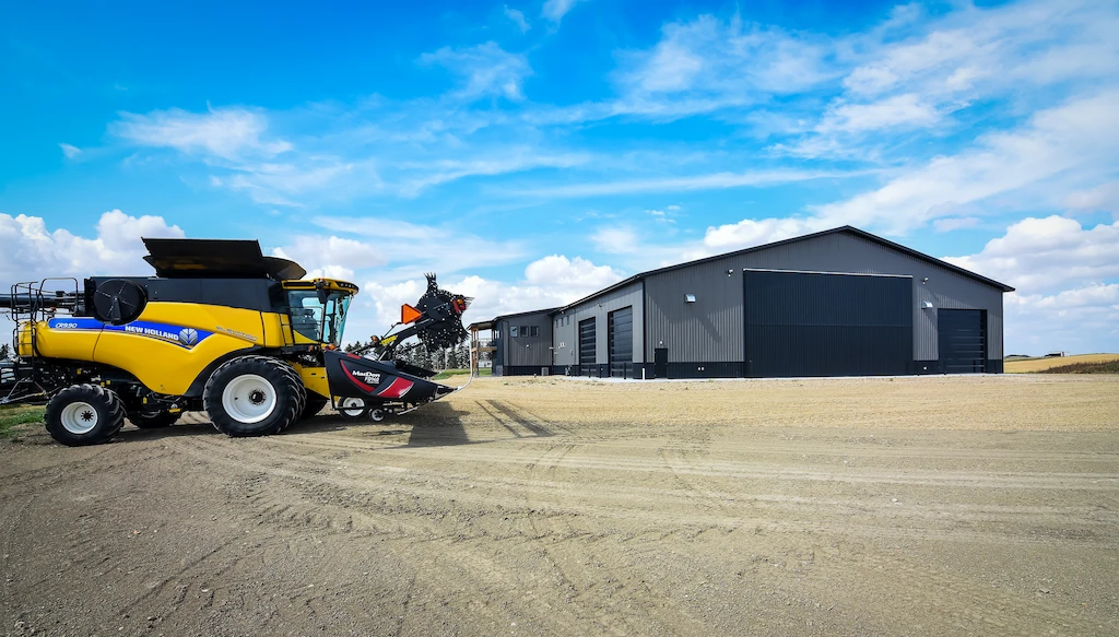 Combine sits outside heated farm shop with office and wash bay