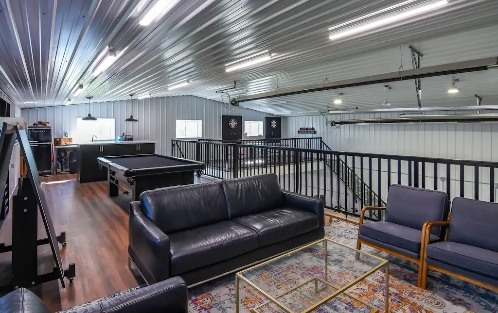 Recreation loft in a hobby shop includes kitchenette, tv viewing area, pool table, and other games