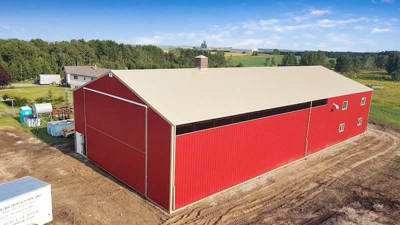 Red 48' x 108' farm shop building features a demising wall to separate the building into heated shop and cold storage