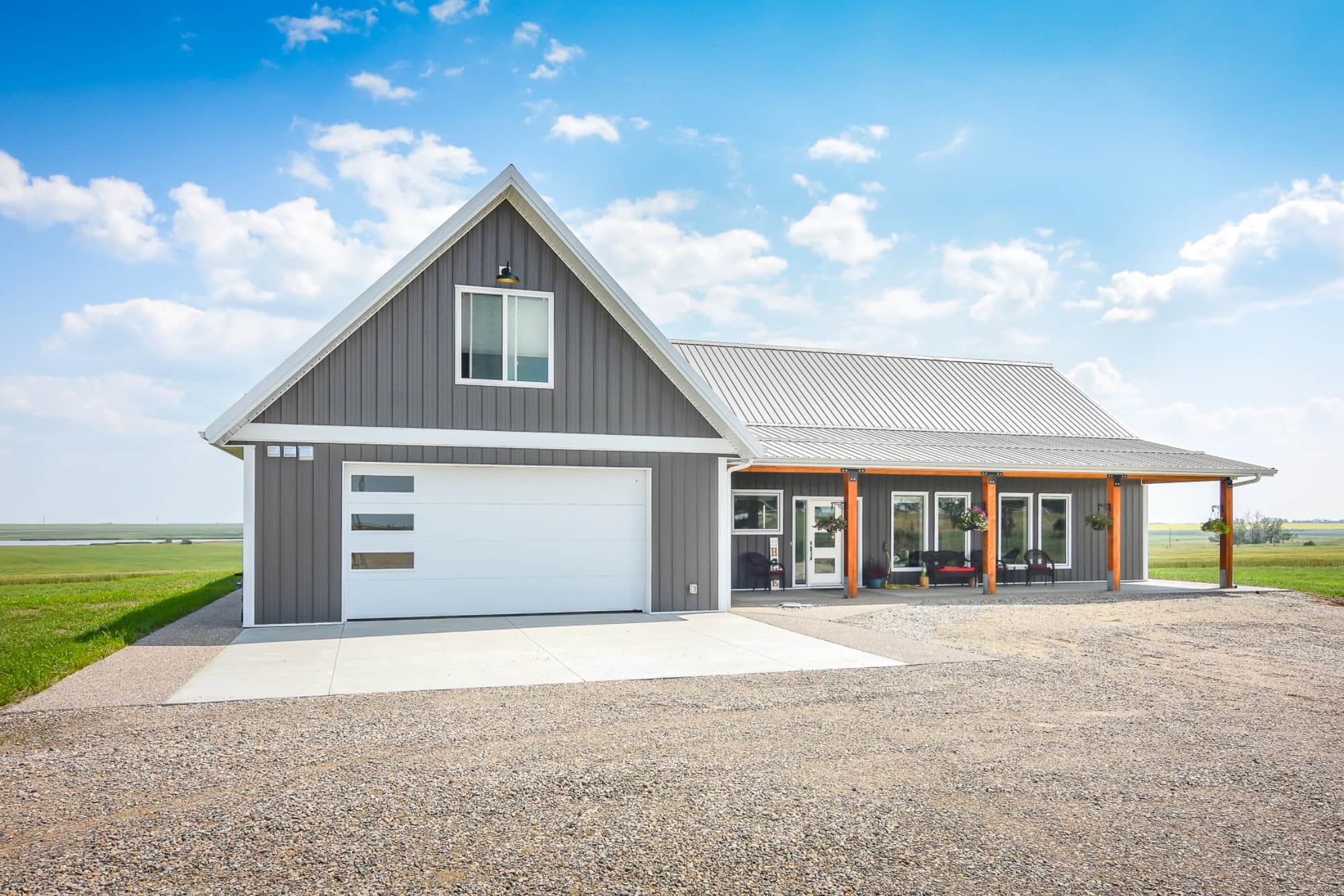A post frame bungalow features a loft above the garage for flexible living space for an office, guest room, or recreation.