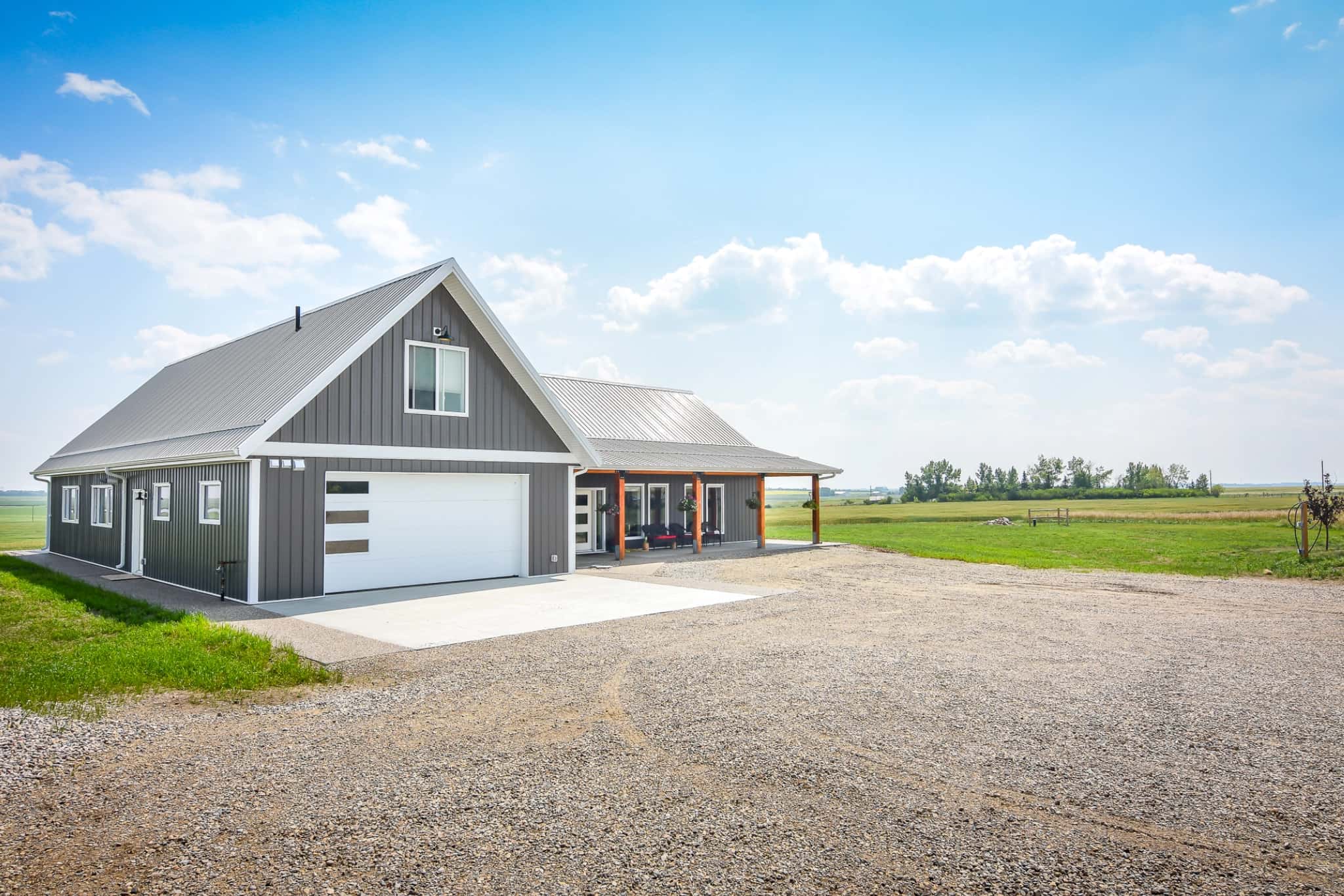 The front of a rural home features subtle details that show the suitability of post frame construction for homes.