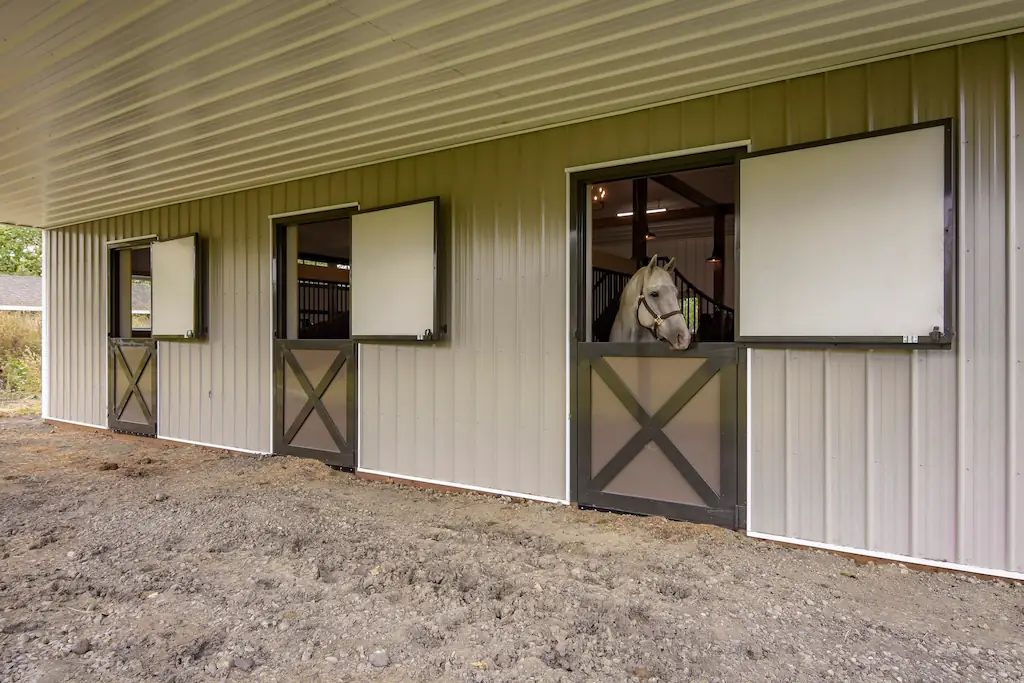 Side view of a 32' x 42' horse barn shows three stalls with with Dutch doors