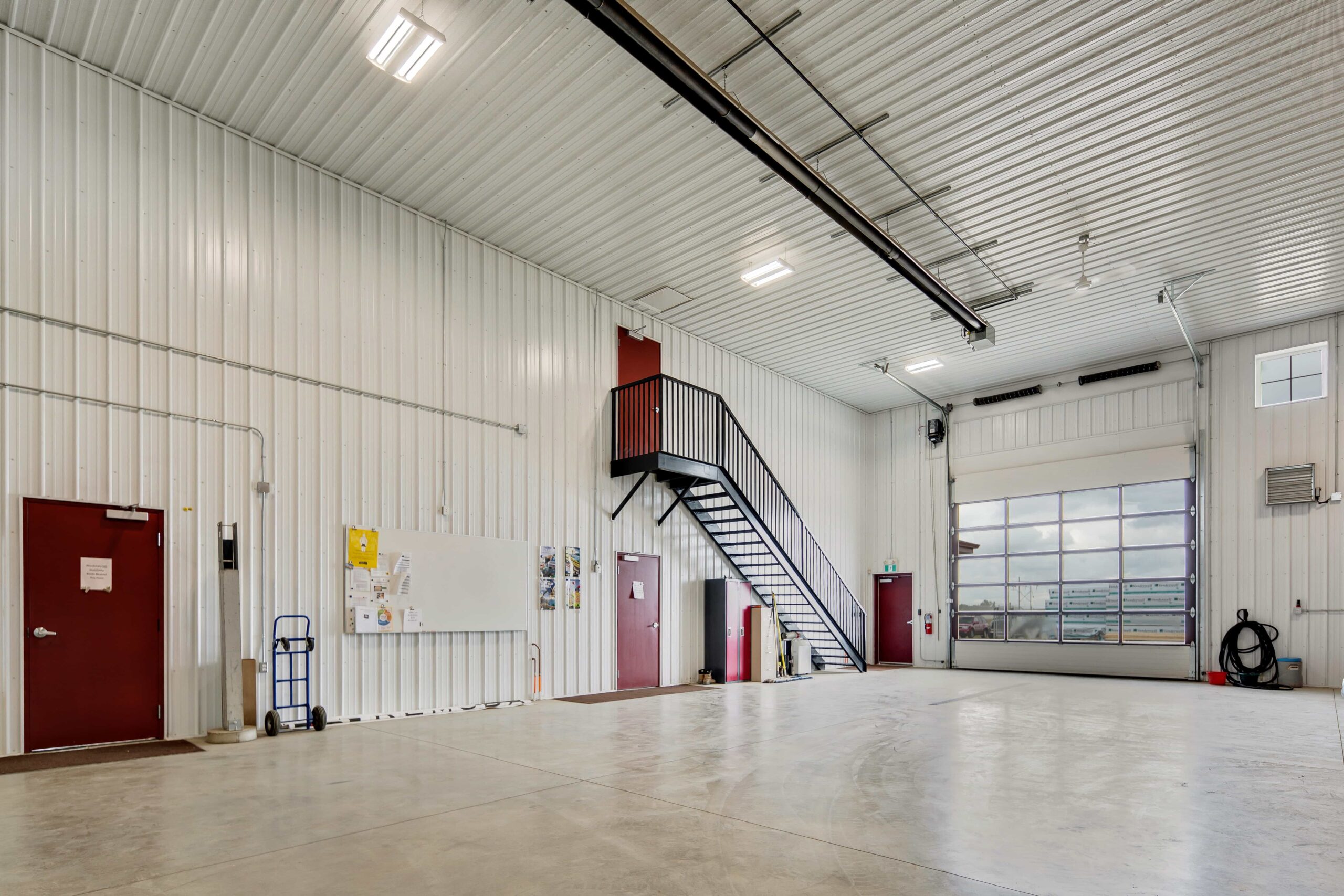 A brightly lit commercial warehouse building, completed with post frame construction