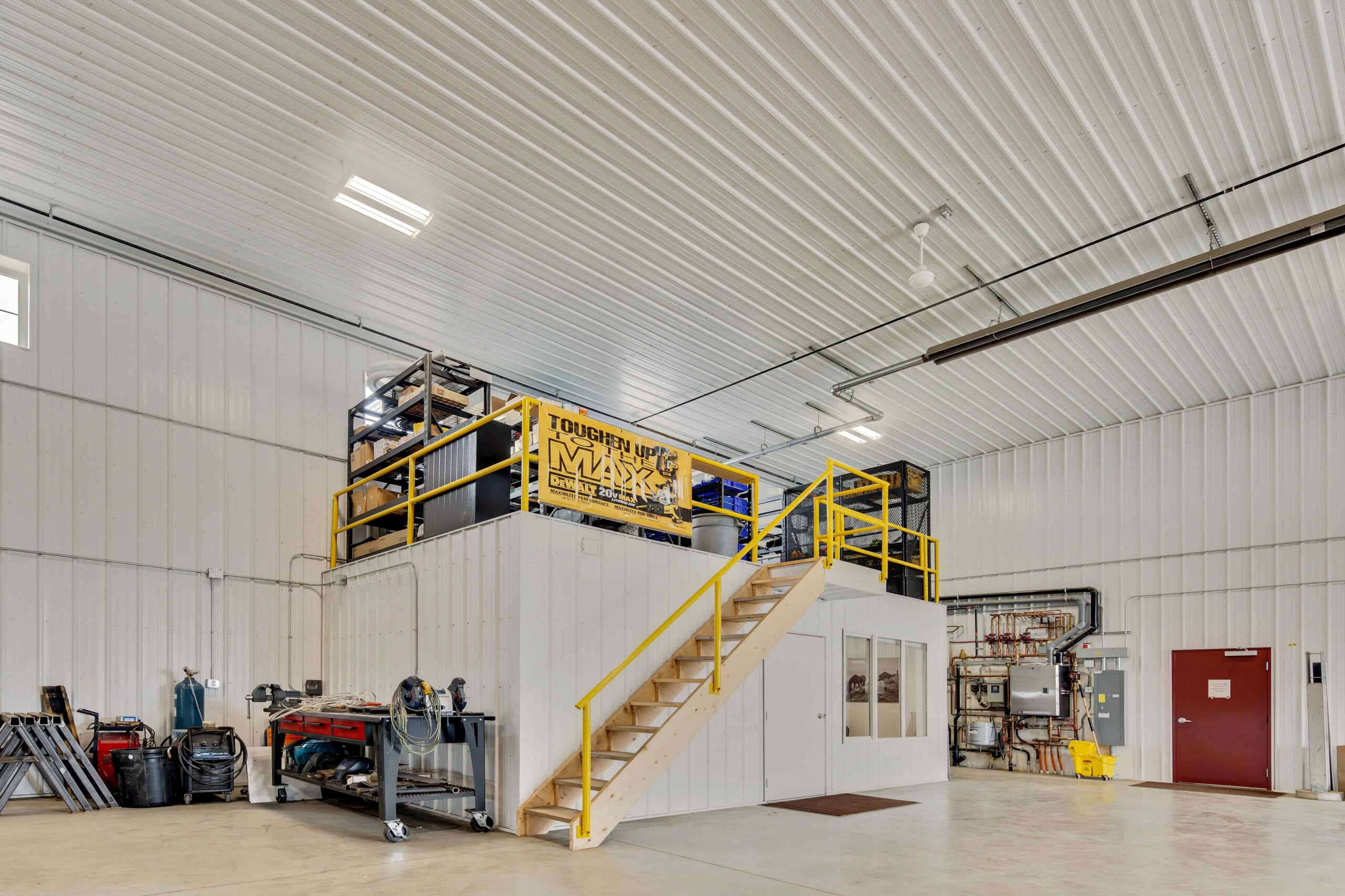 A separated office space is included inside the post frame warehouse to oversee operations