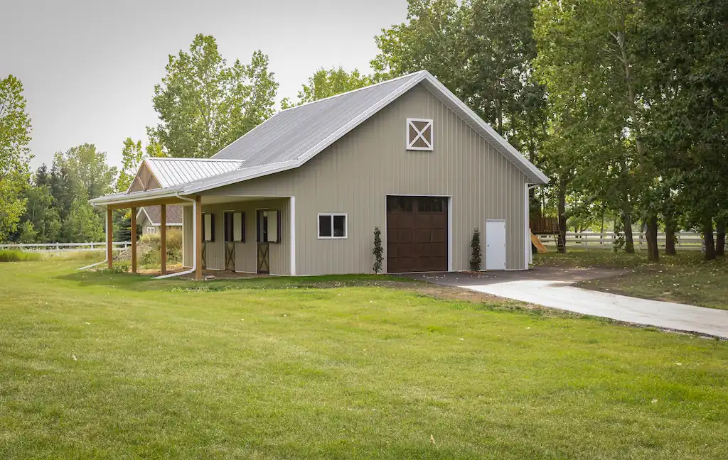 Exterior of a 32' x 42' pole barn with 3 horse stalls and Dutch doors