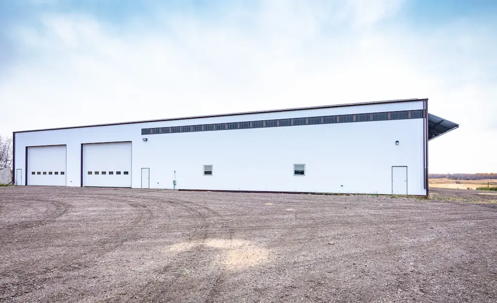 Large agricultural storage building for farm equipment with windows