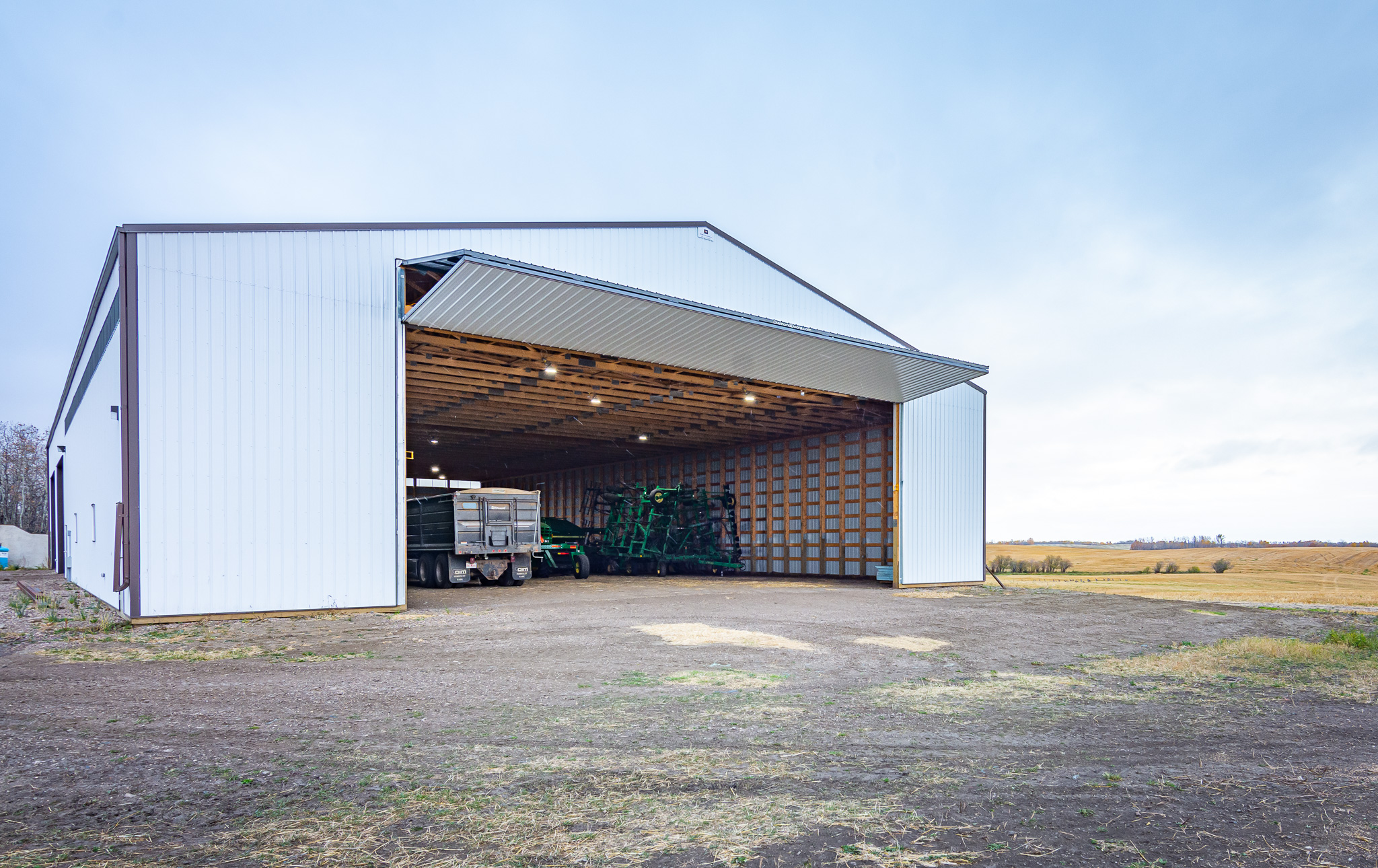 The exterior of an agricultural cold storage building boast a 50' wide bi-fold door