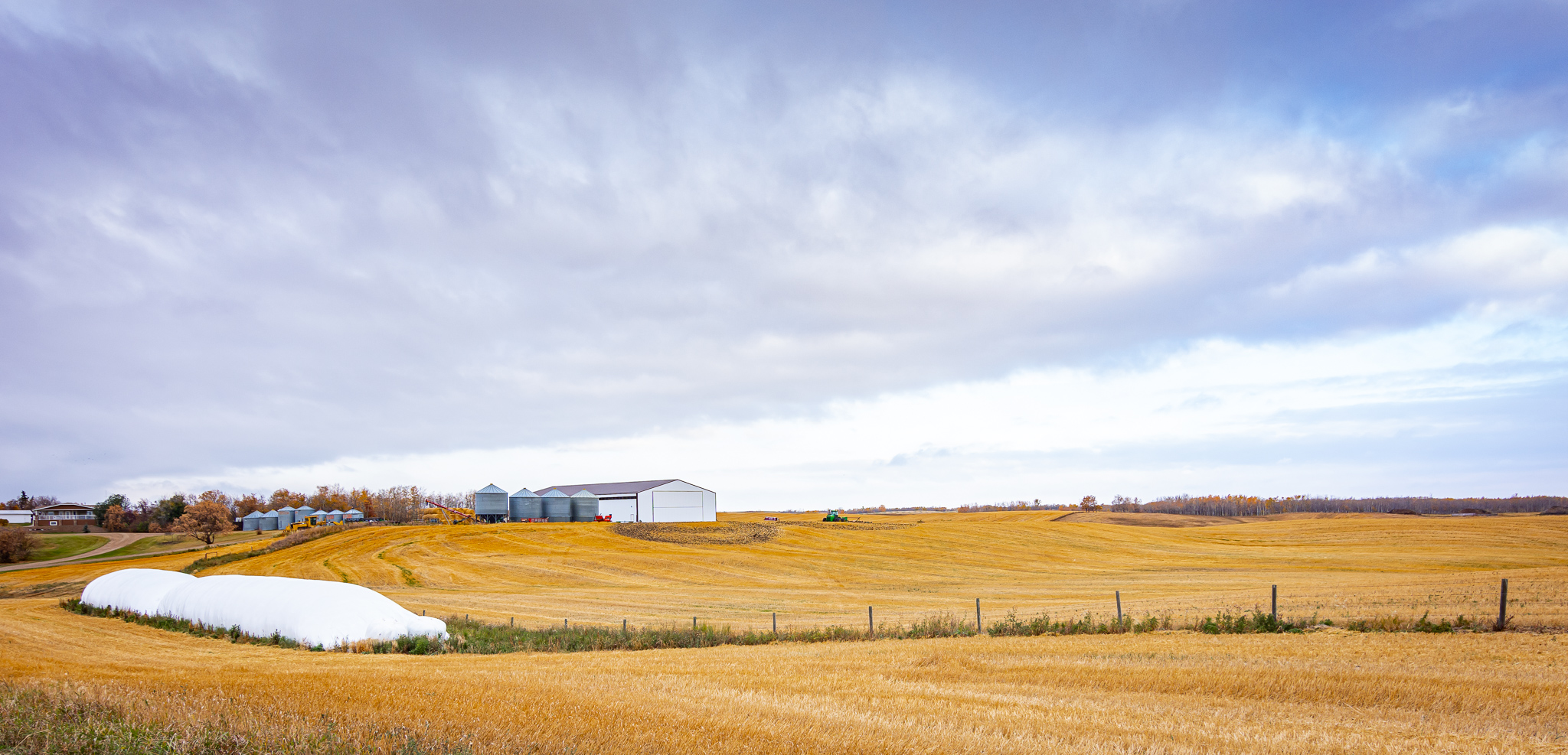 Viewed from afar, the post frame cold storage building sits on scenic farmland