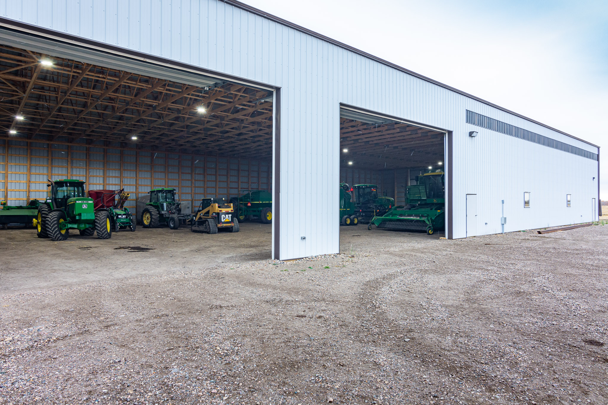 The large overhead doors for equipment access on a farm cold storage building
