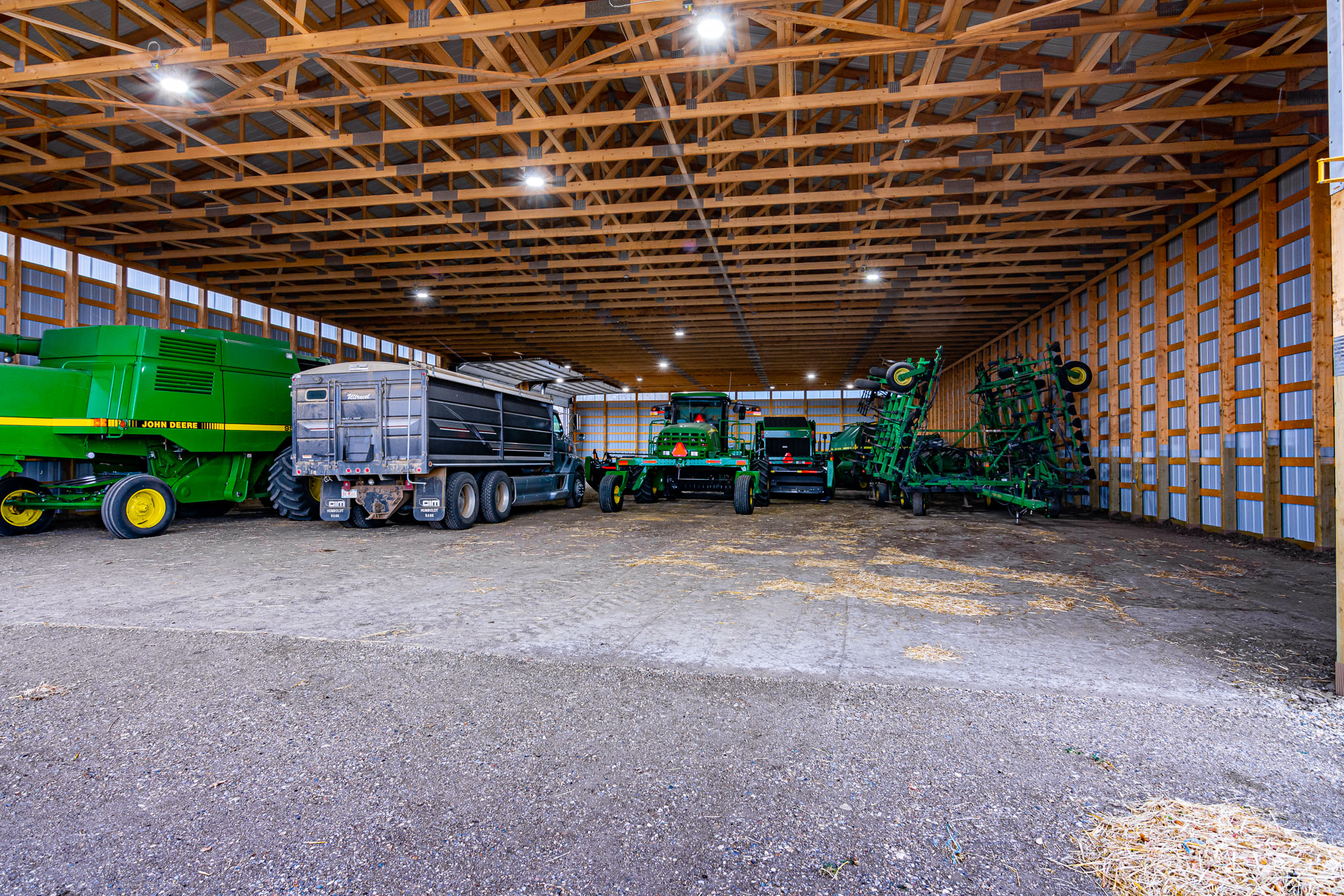 The interior of a post frame cold storage building for agricultural use protecting combines, tractors, and other implements.