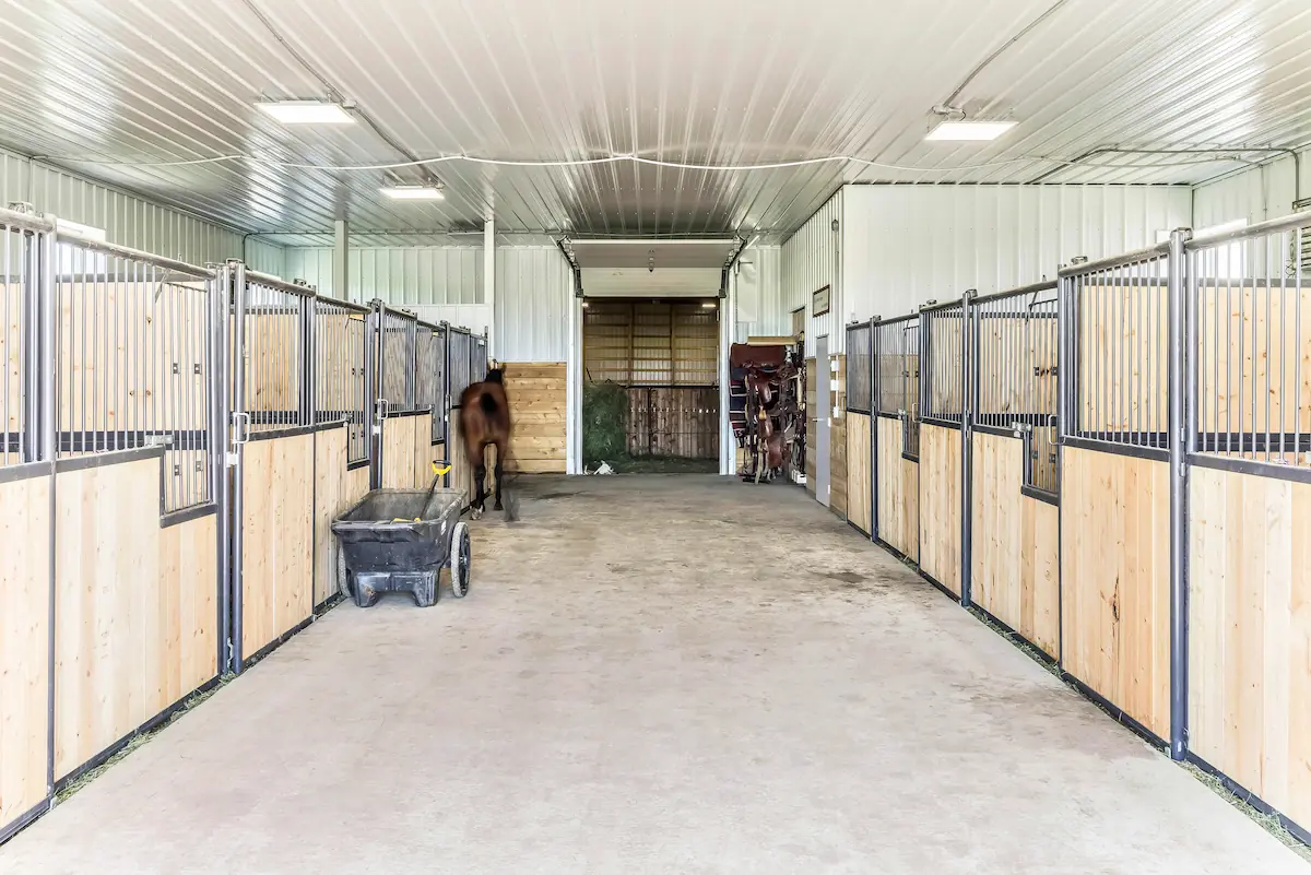 A six stall horse barn with riding arena attached through a small overhead door