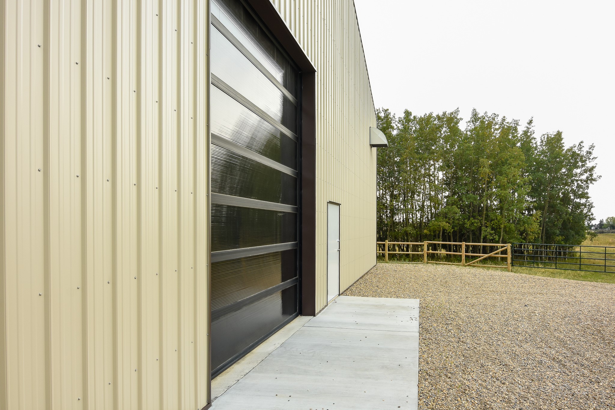 Riding arena with horse stalls also has a sunshine door to allow natural light inside.