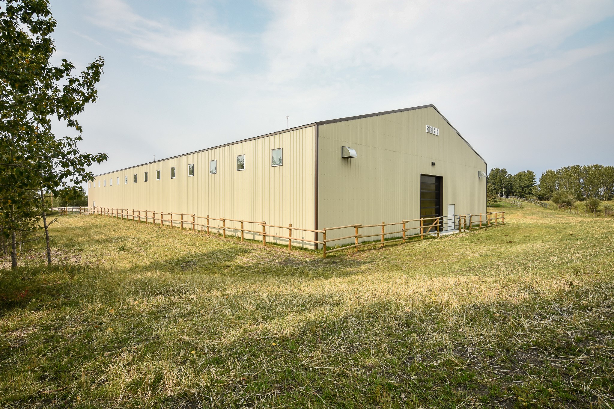 Indoor riding arena designed for equestrian training and horse care facilities