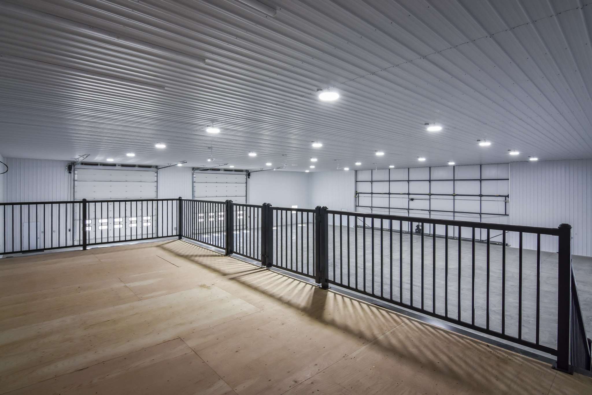 A view from the second-floor mezzanine inside a fully finished farm workshop.