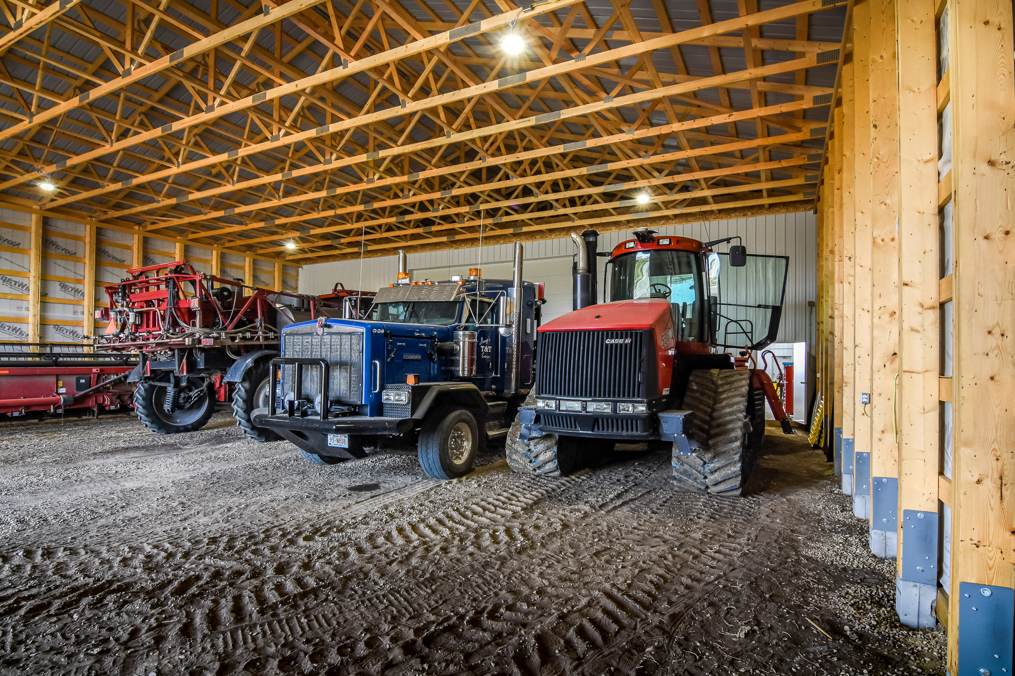 The interior of a post frame cold storage building for farm equipment