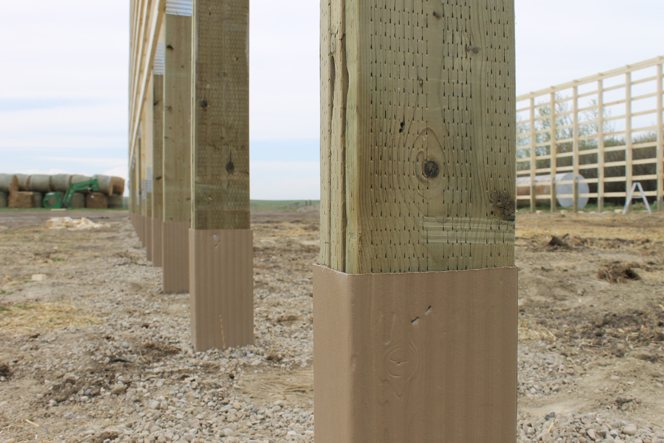 Grade Guard foundation sleeves protect the posts of a cold storage farm building