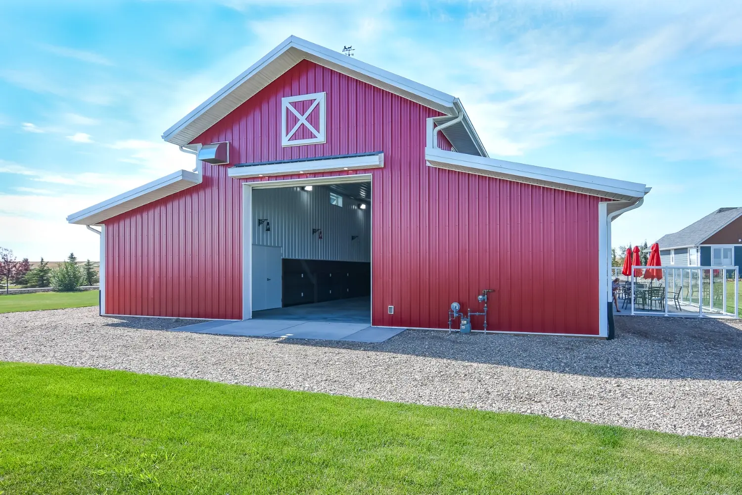An open overhead door reveals the interior of a red hobby shop.