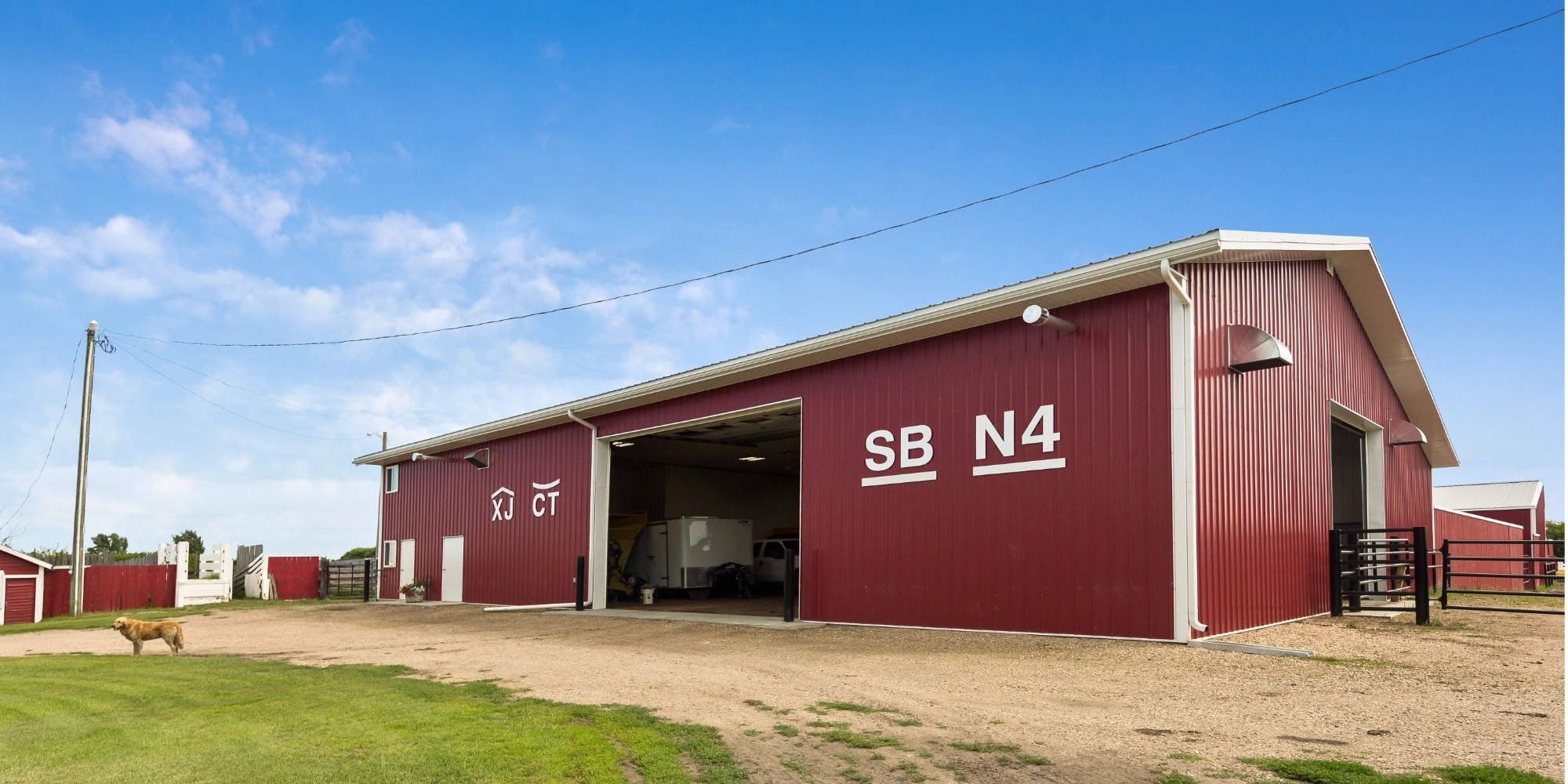 A 50' x 80' red calving barn that is used for equipment storage when not working cattle.