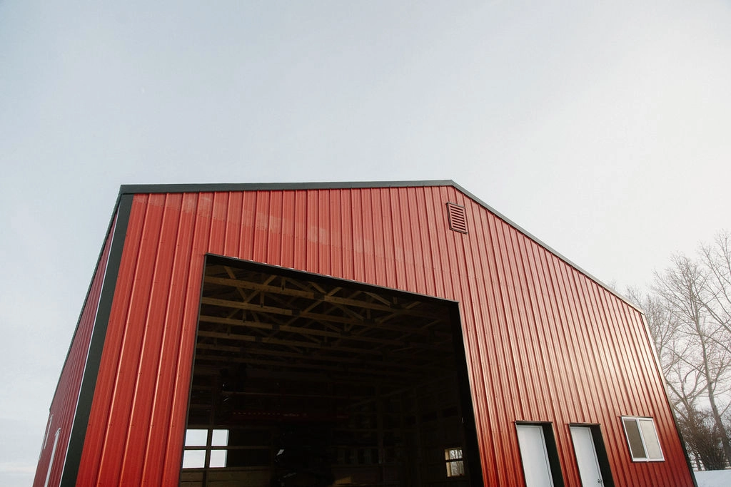 Post frame building being constructed in winter