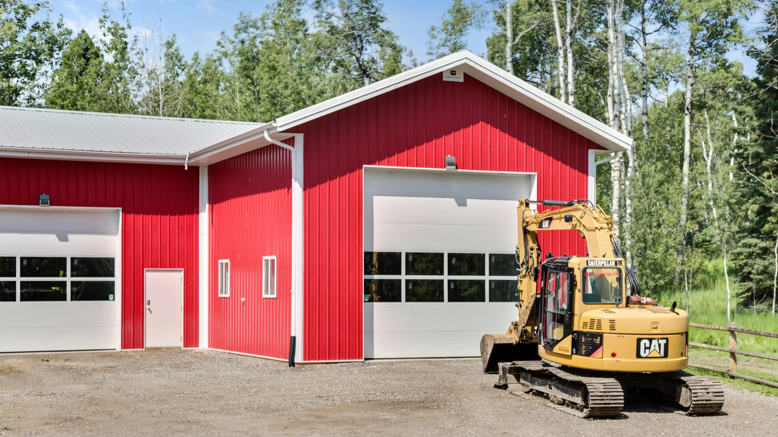 Transparent overhead door panels on an L shaped garage design illuminates the interior