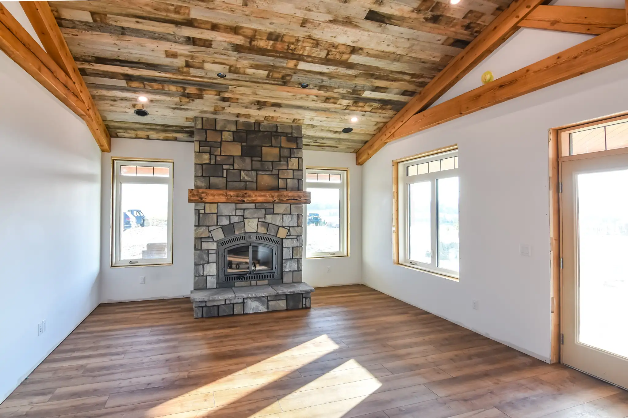 Living room of a small barndominium layout, including a fireplace.