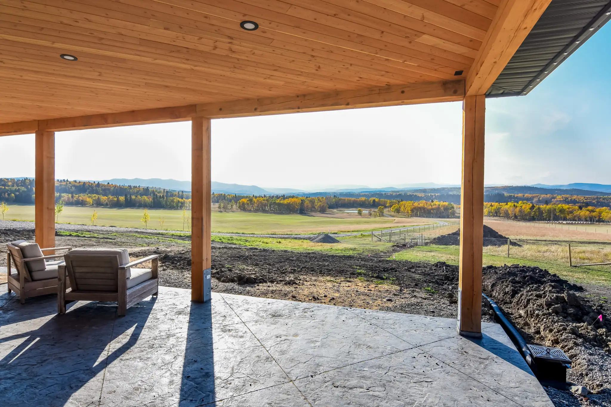 Scenic countryside and foothill view from underneath a barndominium with wrap around porch