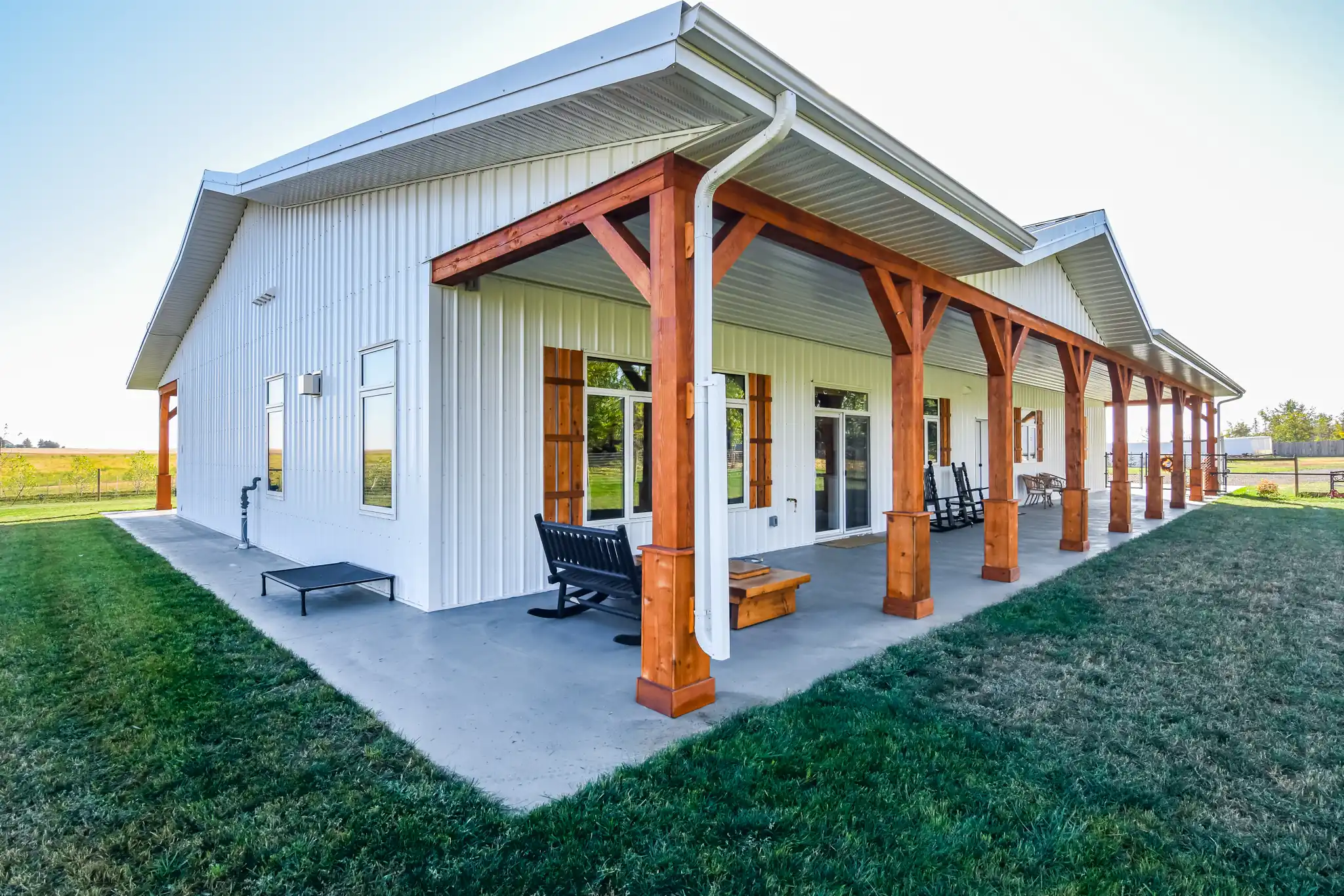 Wood-tone exterior details on a rustic barndo with white metal siding