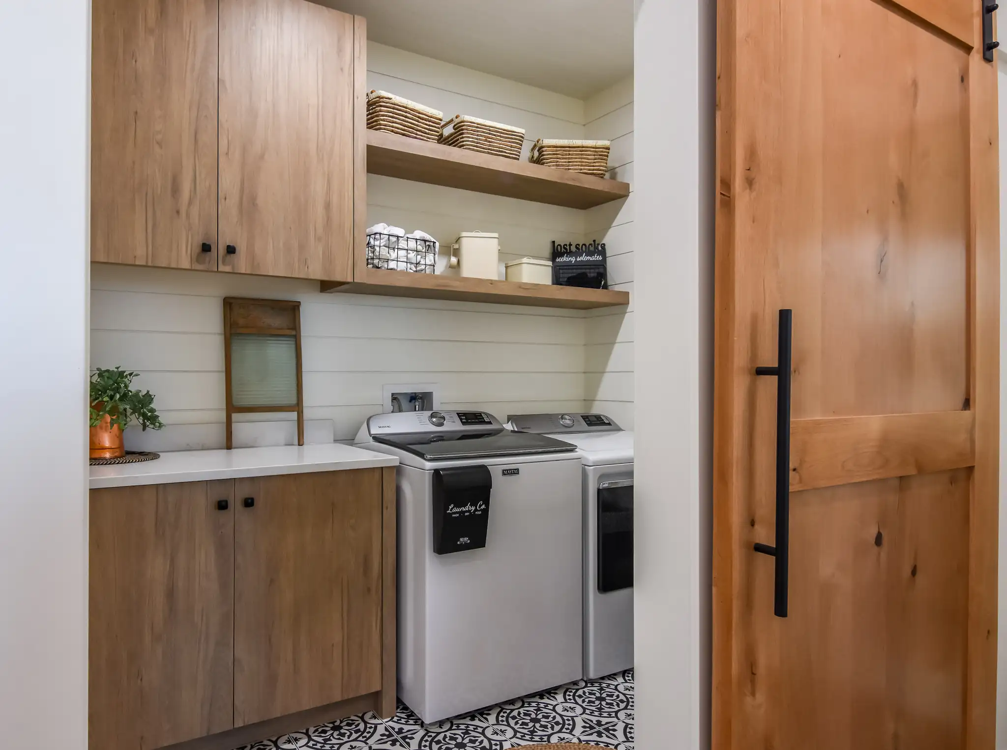 Modern laundry room in a 3 bed, 2 bath barndominium layout