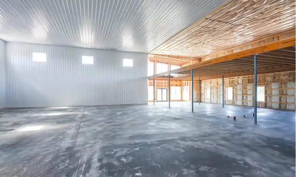 Partially finished post frame building interior with insulation