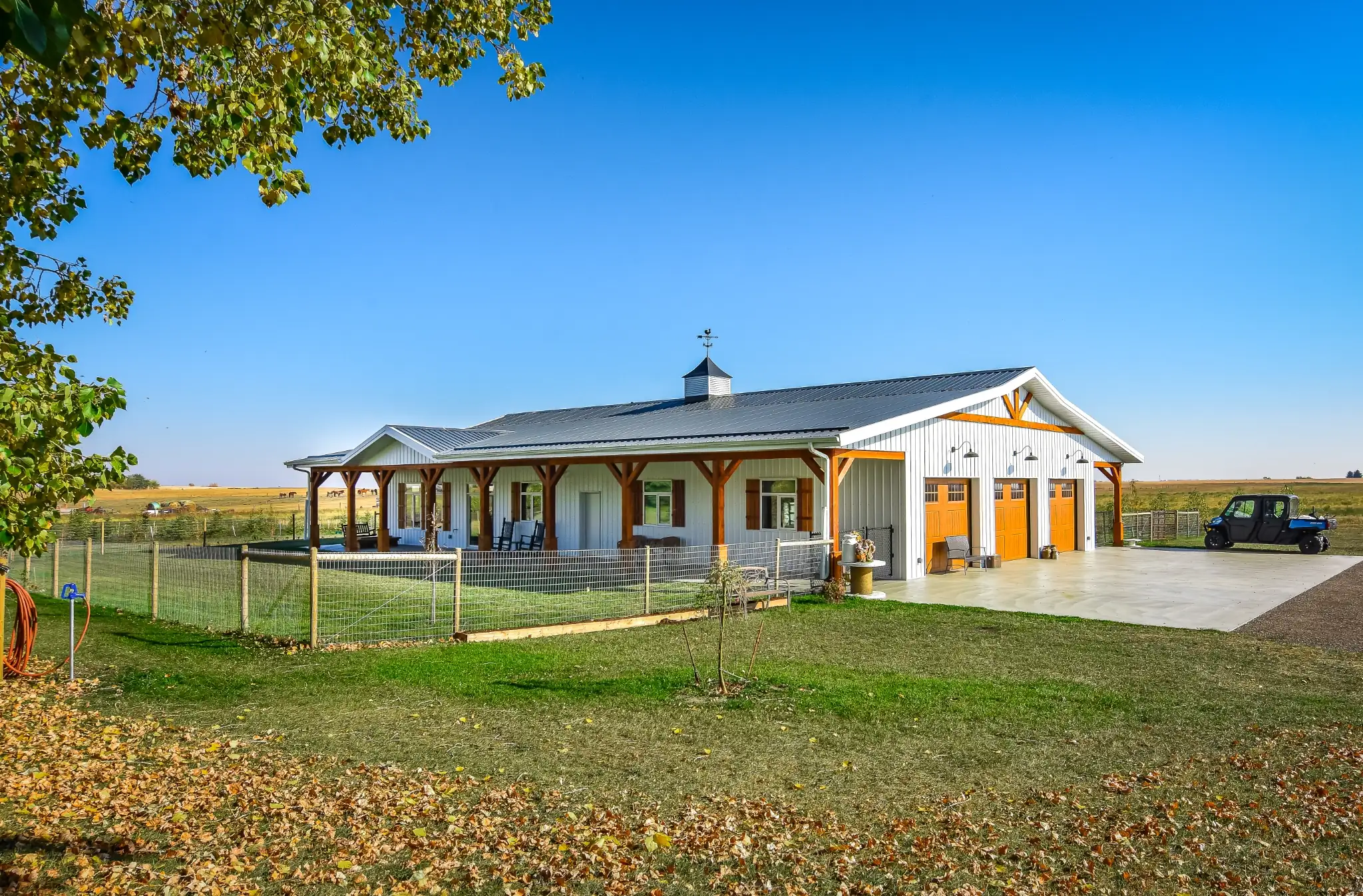 One story barndominium exterior with white siding and wood-tone accents