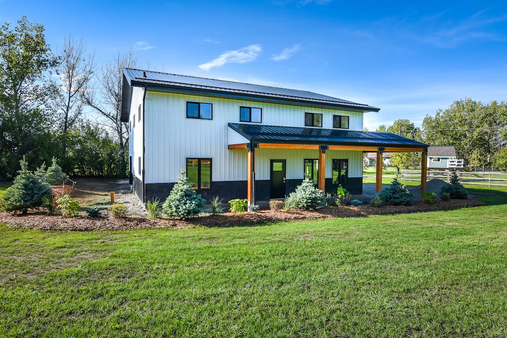 Post frame acreage building with porch