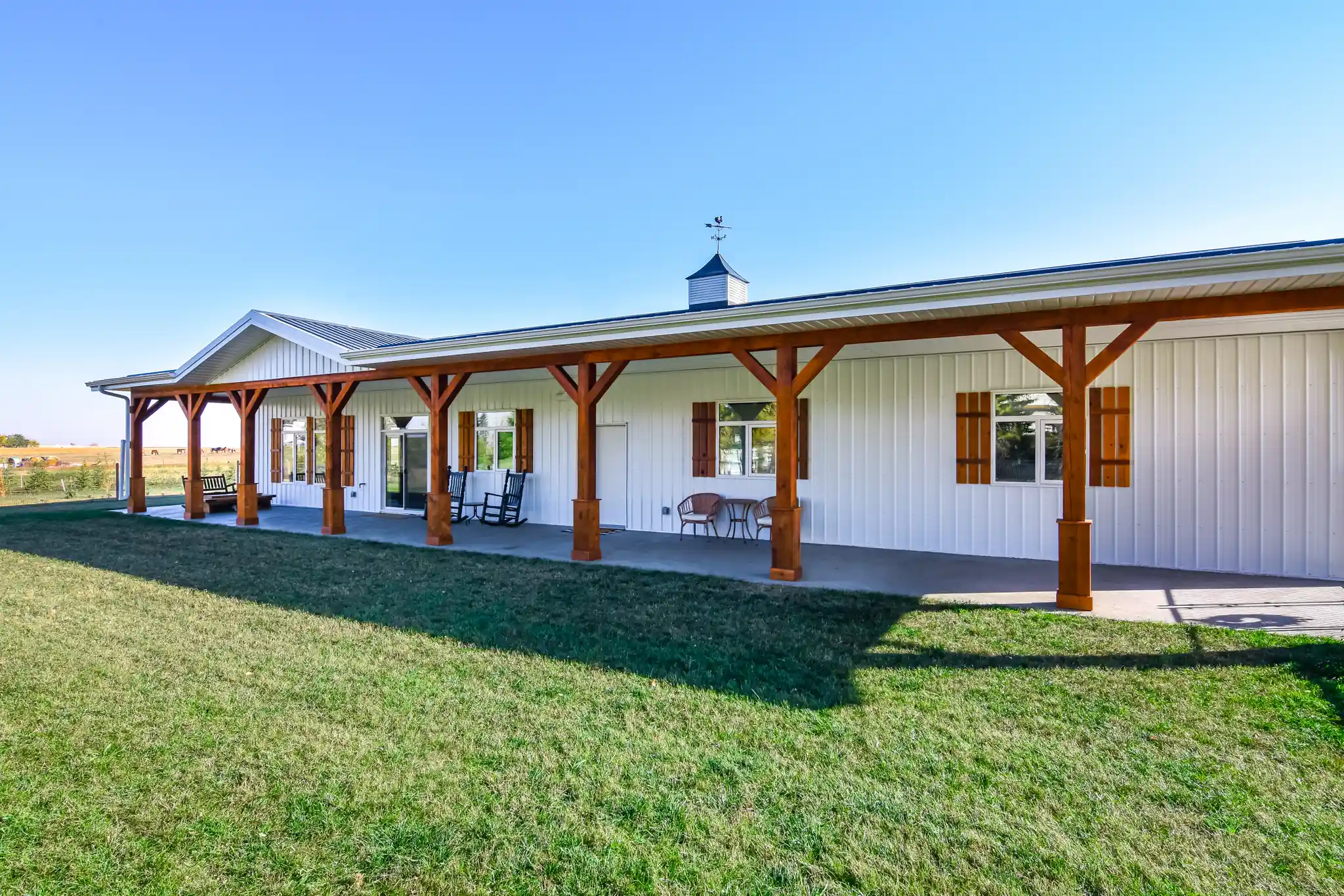 Wood-tone exterior details on a rustic barndo with white metal siding