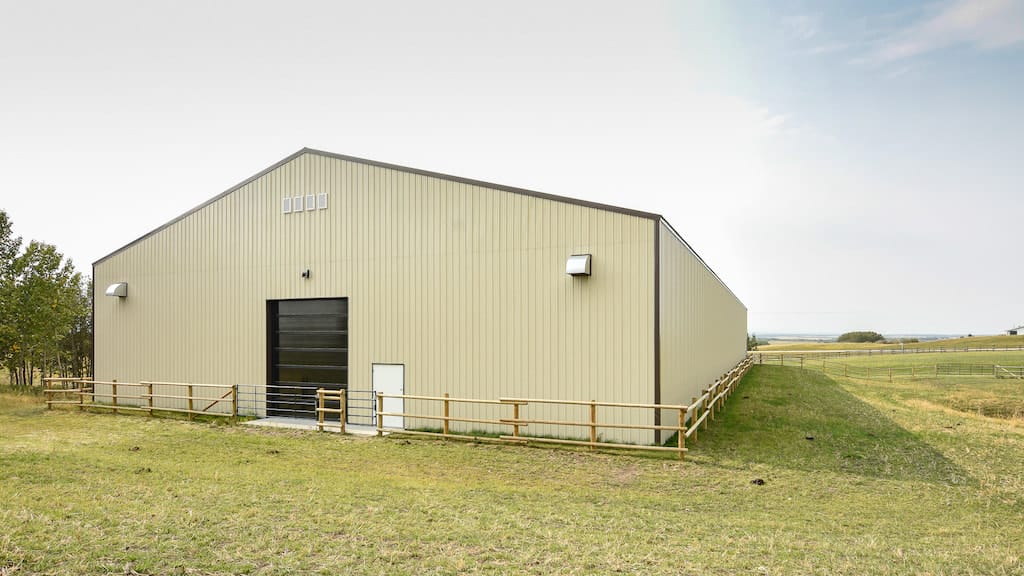 Large post frame equestrian facility used for riding and training horses