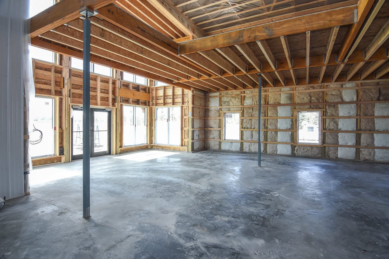 The interior of a post frame building shows the insulation benefits of post frame vs stick frame